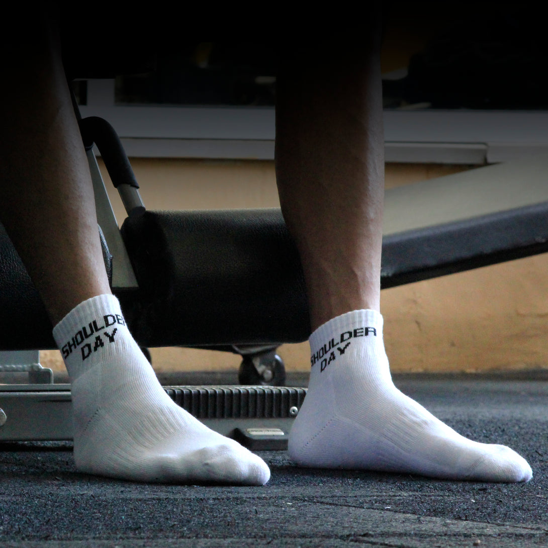 White ankle socks 'shoulder day' text , soft cotton blend, durable for gym days from The Sock Street.